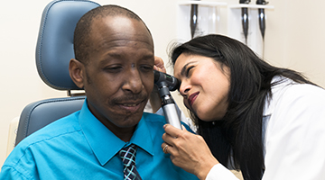 doctor examining patients ear