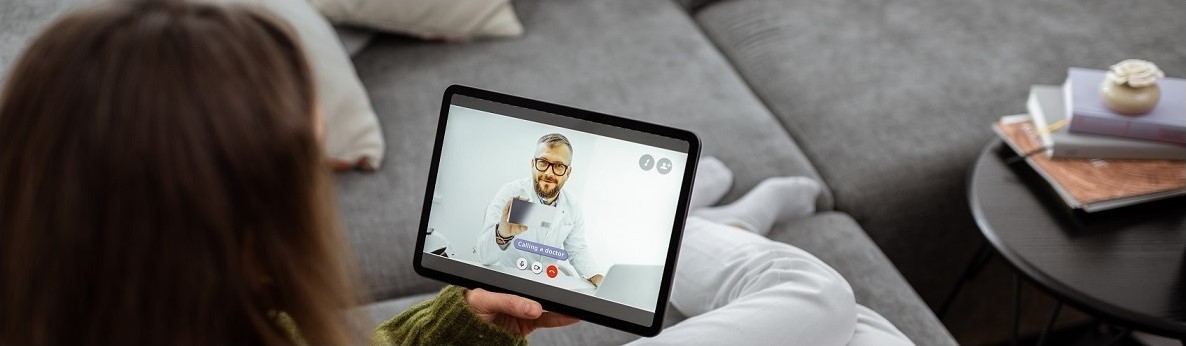 woman having a telehealth visit with a tablet