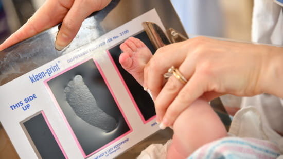 Nursing recording a footprint of a newborn