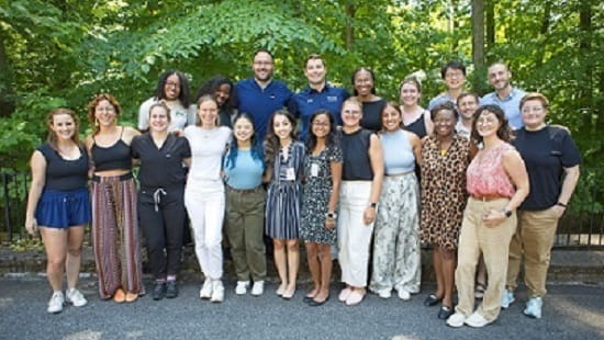 Pediatric residents standing in front of trees on the orientation retreat for class of 2027.