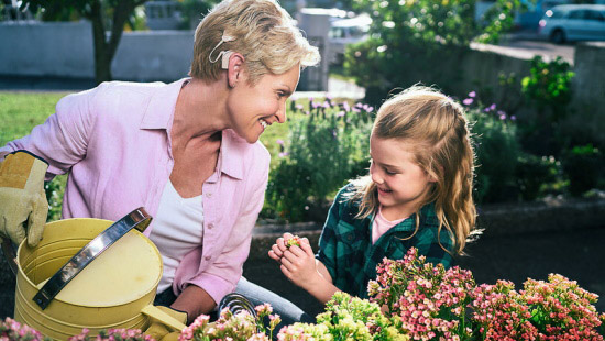 Woman with a cochlear implant with her granddaughter