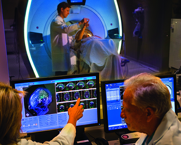 Dr. Howard Eisenberg looking at brain scans