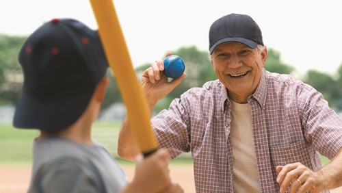 Man throwing ball to child