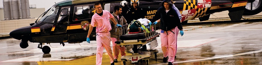 shock trauma physicians transporting patient from helicopter
